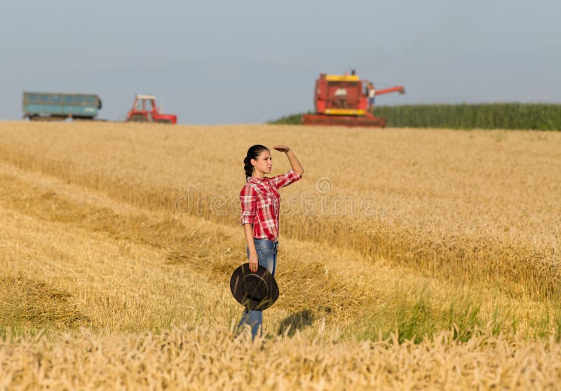 Girl on wheat field during harvest