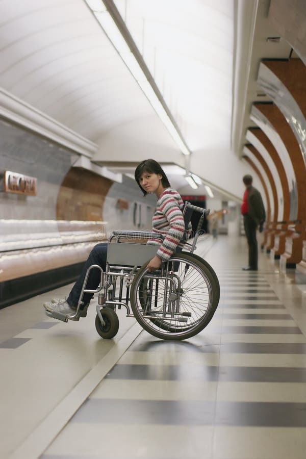 Girl in wheelchair in subway