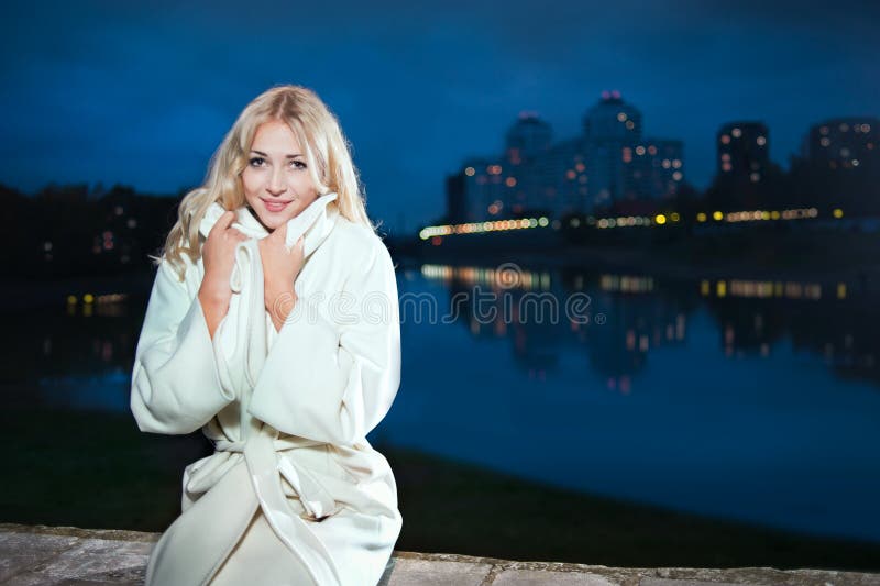 A girl in a white coat stock photo. Image of light, river 29026530