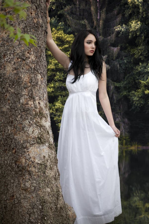 Girl in white dress in forest