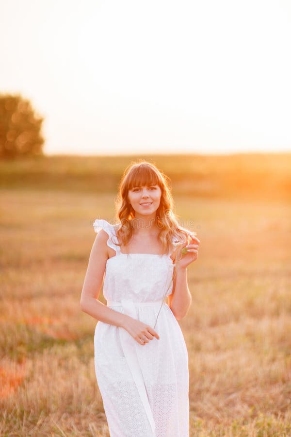 Girl in white dress with spikelets. Woman in field, place for text. Spike and girl in field. Late summer and early stock images Girl in white dress with spikelets. Woman in field, place for text. Spike and girl in field. Late summer and early stock images