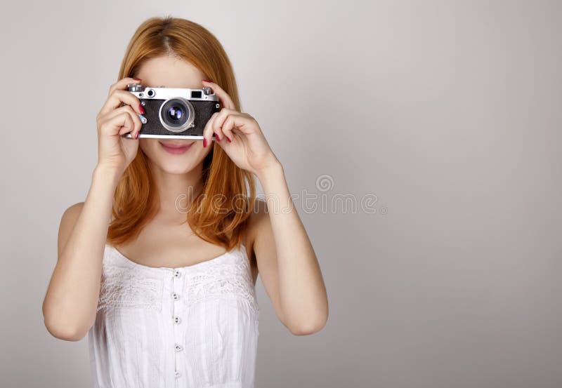 Girl in white dress with vintage camera.