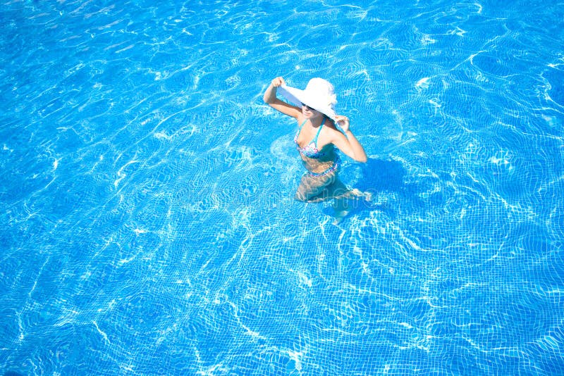 Girl, white hat and swimming pool