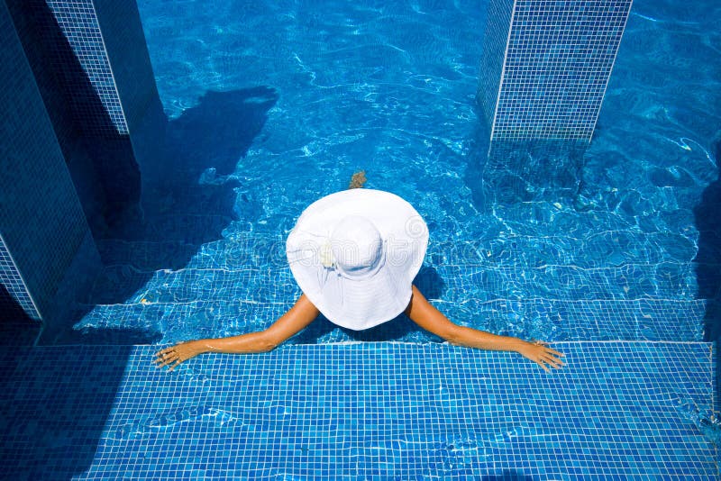 Girl, white hat and swimming pool