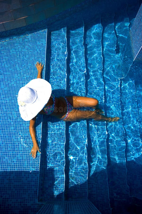 Girl, white hat and swimming pool