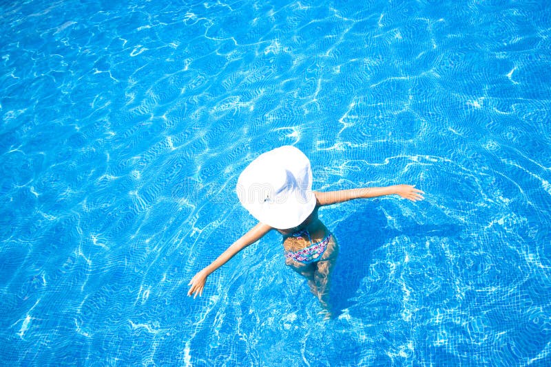 Girl, white hat and swimming pool