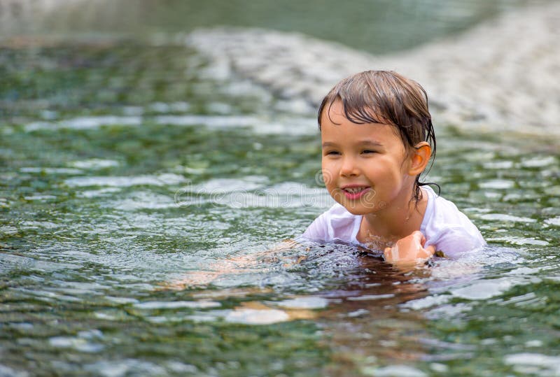 Girl who swims dressed in the downtown fountain