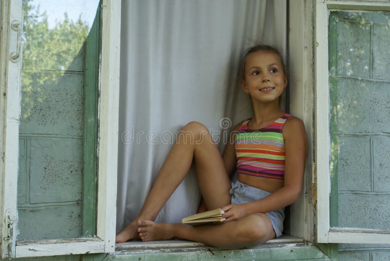 Girl in window stock photo