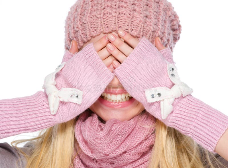 Girl in winter clothes covering eyes with hands stock photos.