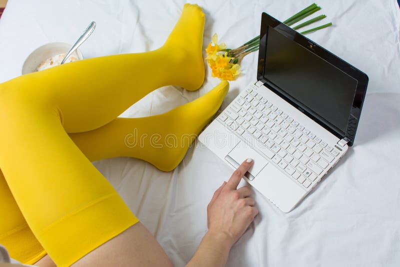 Girl working and eating cereals for breakfast in bed. Girl working and eating cereals for breakfast in bed