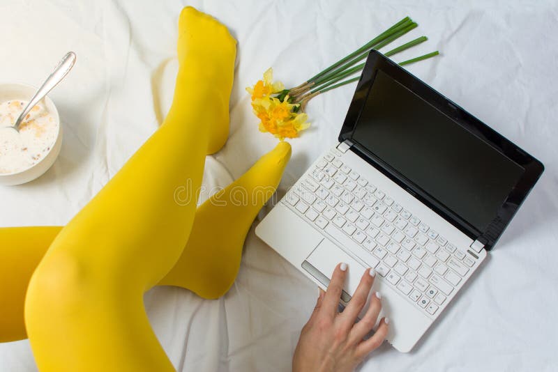 Girl working and eating cereals for breakfast in bed. Girl working and eating cereals for breakfast in bed