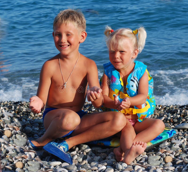 The girl of 3 years, the blonde, and her elder brother on a sea