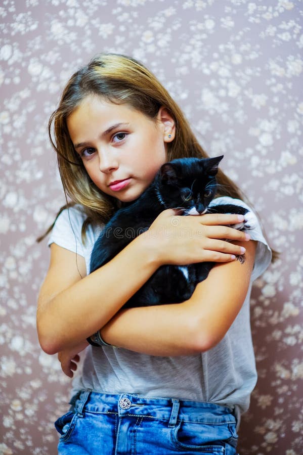 Girl 10 years old and a black and white kitten