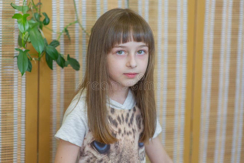 Girl 9 Years Old on a Green Background. Hairdressing, Hair Cutting