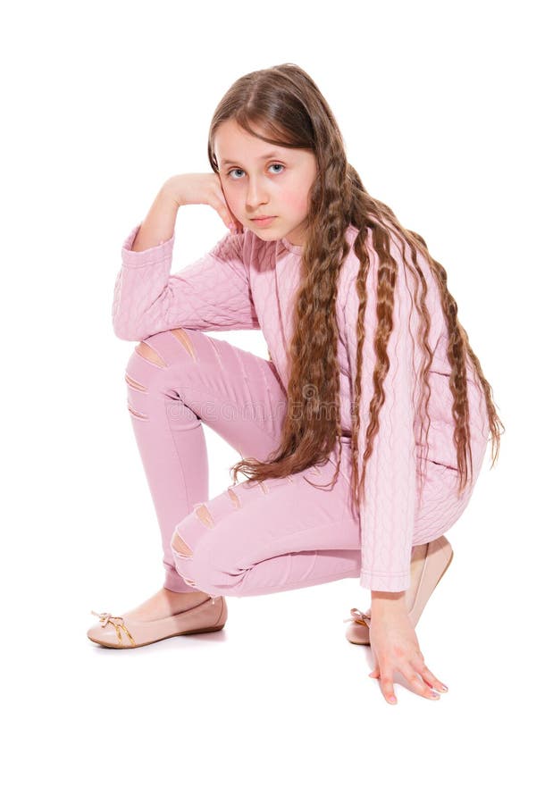 A girl of 10-11 years old with long beautiful hair sat on one knee. Isolation on a white. stock images A girl of 10-11 years old with long beautiful hair sat on one knee. Isolation on a white. stock images