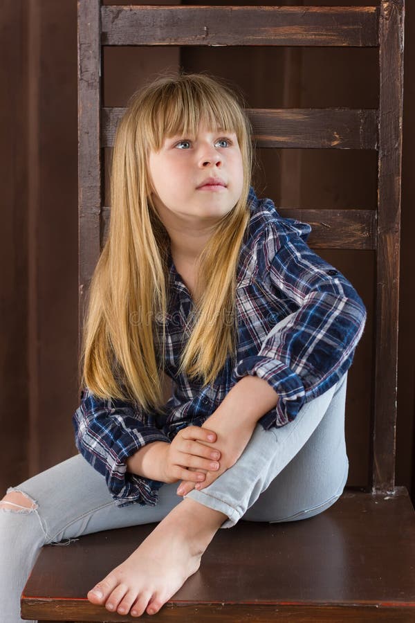 Girl 6 years old sitting on a high chair