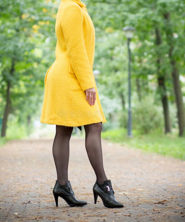 A Girl in a Yellow Coat is Walking in the Park Stock Image Image of