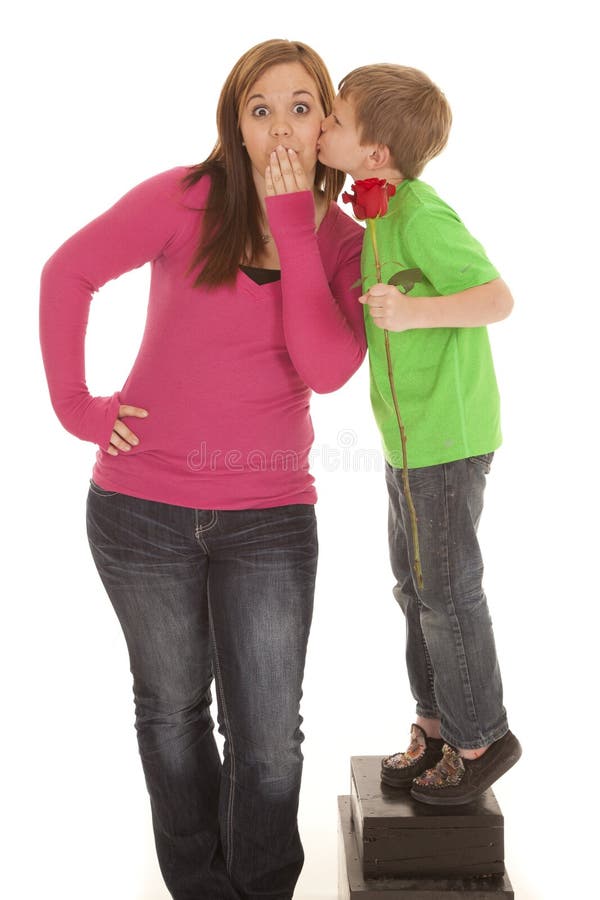 Girl and young boy hold rose kiss cheek