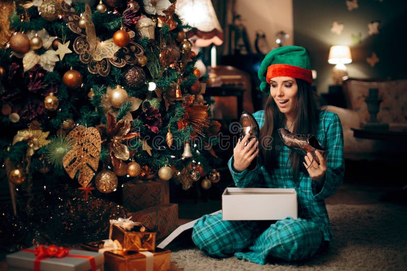 Happy Woman Receiving Silver Shoes for Christmas royalty free stock photos Happy Woman Receiving Silver Shoes for Christmas royalty free stock photos