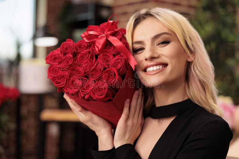 Girlfriend holding red roses bouquet celebrating love holiday