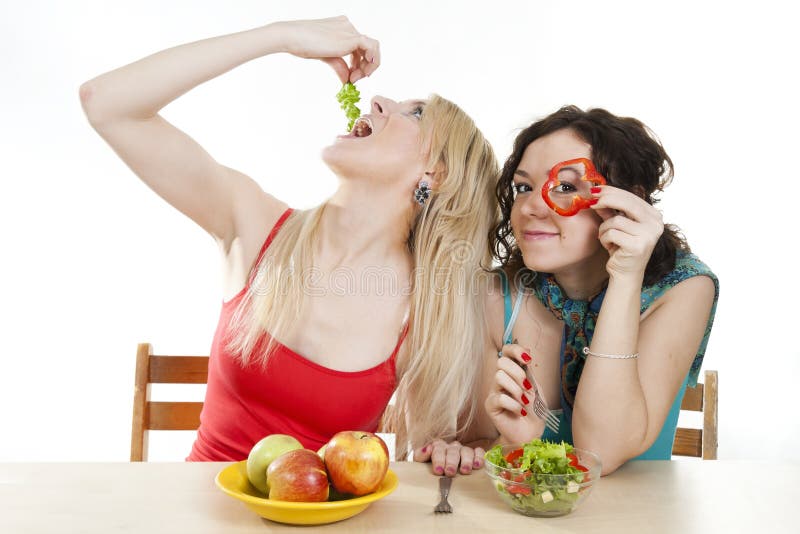 Girlfriends cheerfully play with food