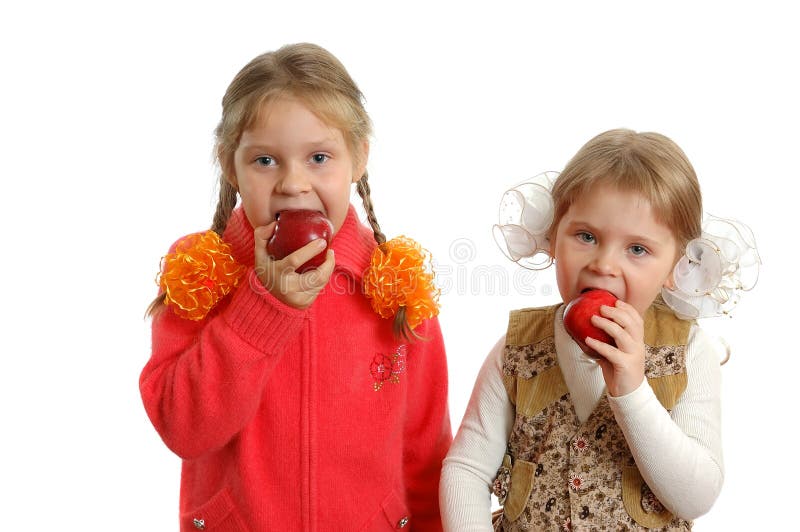 Girls bite apples on white