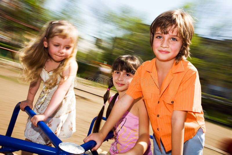 Girls and boy on carousel