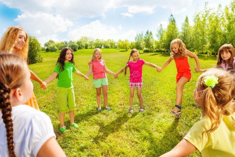 Girls dance in the park in circle