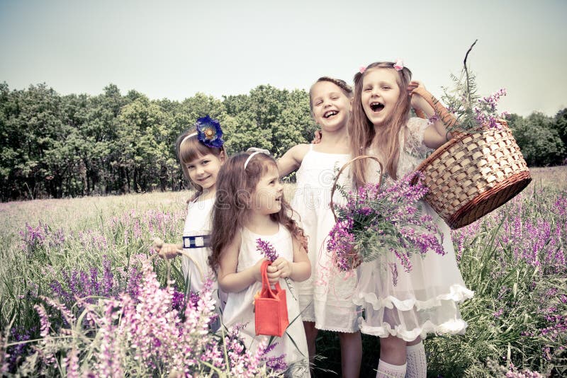Girls holding flower baskets stock photo