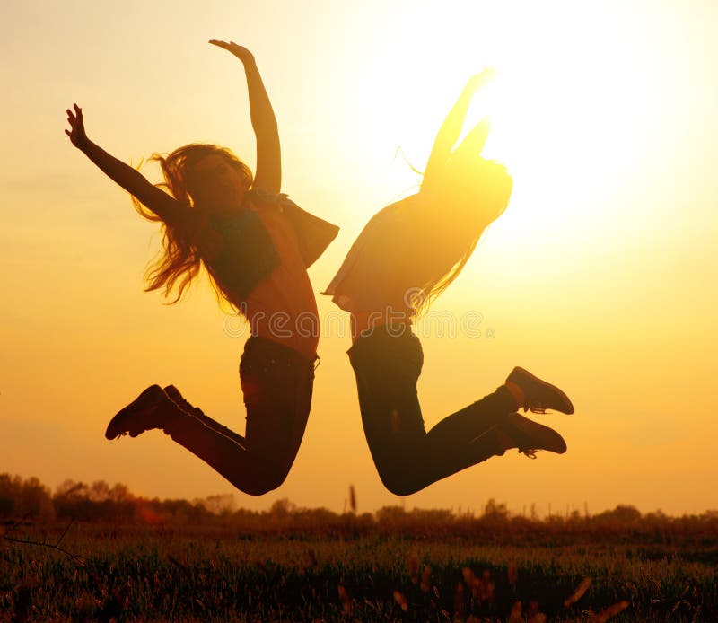 Girls jumping over sunset stock photos Girls jumping over sunset stock photos