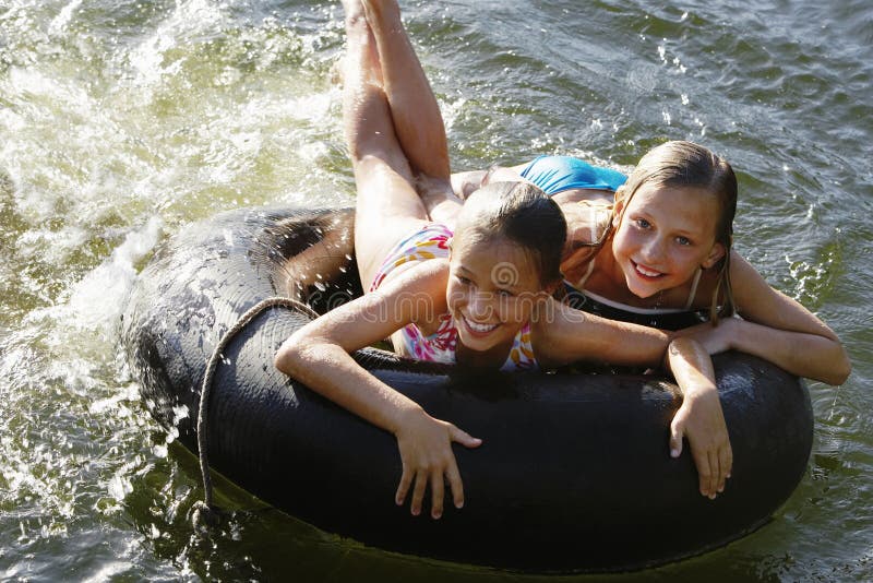 Girls Lying On Float Tube At Lake Stock Image Image Of Girl