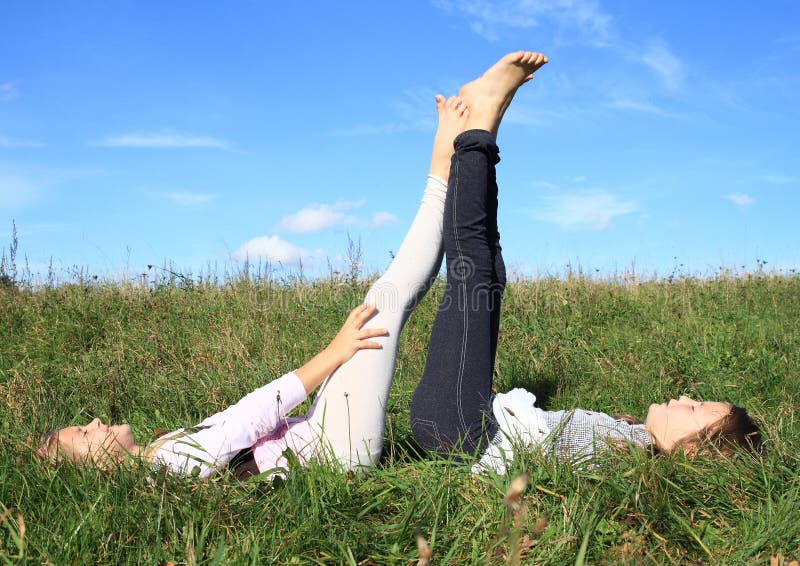 Girls lying in grass