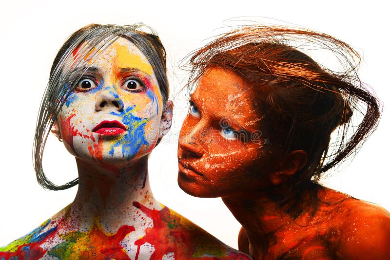 Girls with painted faces in different colors and red colors, body art. Girls with painted faces in different colors and red colors, body art