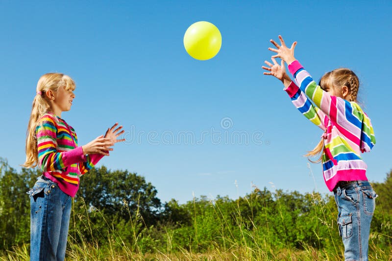 Girls playing with the ball stock images