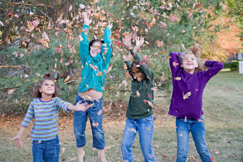 Girls Playing in Leaves stock image