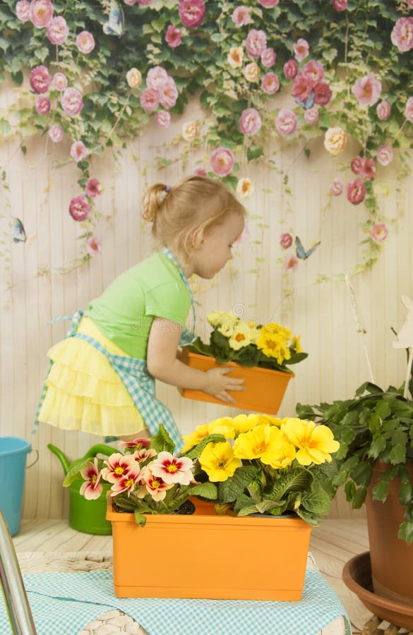 Girls of three years care for flowers
