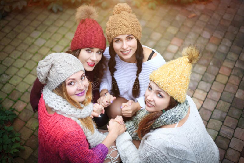 Girls in Warm Knitted Clothes and Hats Hug, Top View. Autumn Day, a ...