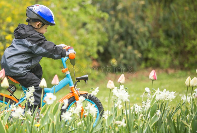 Little boy learning to ride his first bike in the park. Little boy learning to ride his first bike in the park