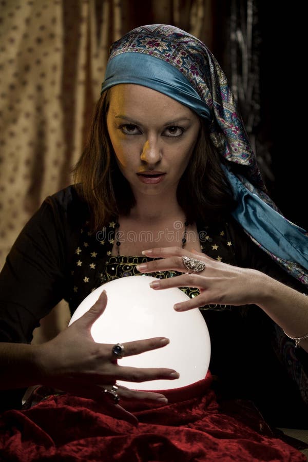 Fortune teller psychic gypsy behind crystal ball. Fortune teller psychic gypsy behind crystal ball