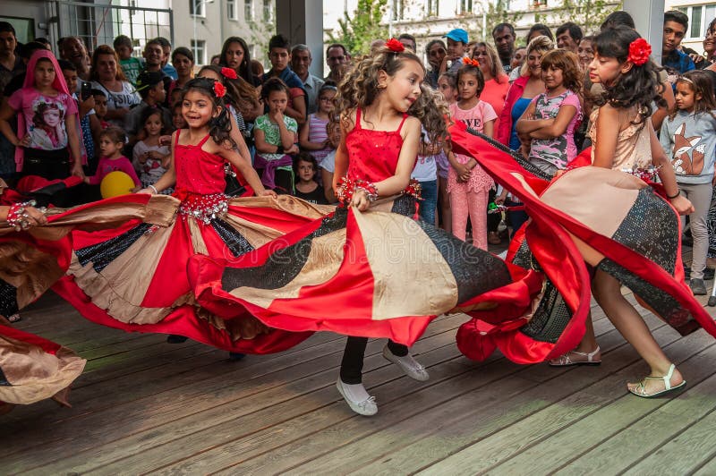 Brno, Czech Republic. 06-11-2016. Girls dancing with traditional costumes at a Festival of Roma people Gypsies in Brno attended by people from the community, with activities for children and adolescents. Brno, Czech Republic. 06-11-2016. Girls dancing with traditional costumes at a Festival of Roma people Gypsies in Brno attended by people from the community, with activities for children and adolescents