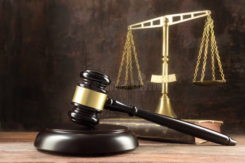 Judge gavel, book and scales on the wooden lawyers desk, justice symbols for social balance in law and court, dark background with copy space, selected focus, narrow depth of field. Judge gavel, book and scales on the wooden lawyers desk, justice symbols for social balance in law and court, dark background with copy space, selected focus, narrow depth of field