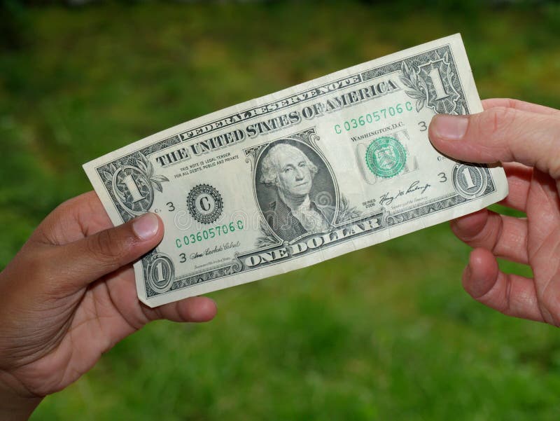 Giving dollar bill to kids hand