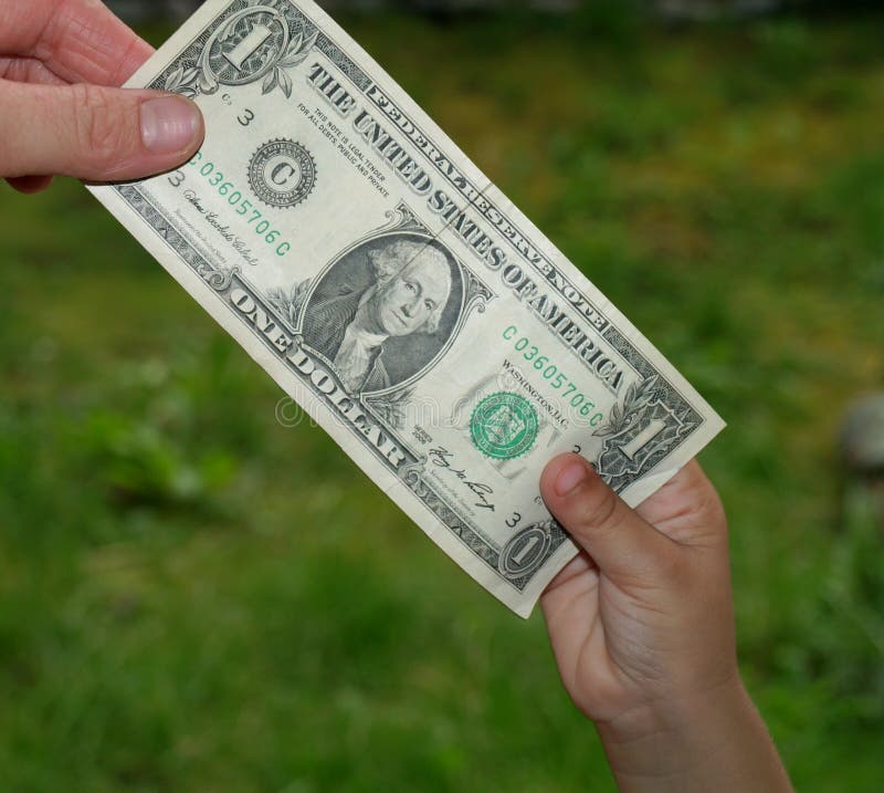 Giving small child dollar bill. Giving small child dollar bill