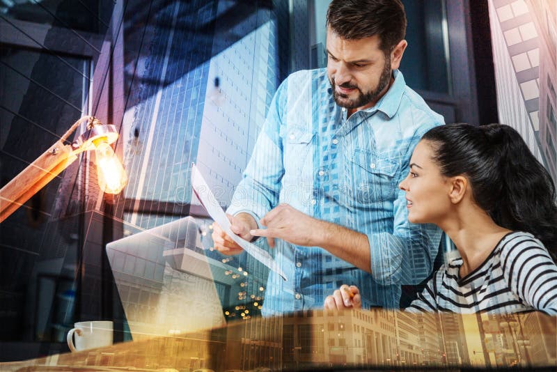 Cheerful boss showing a list of tasks to his responsible employee