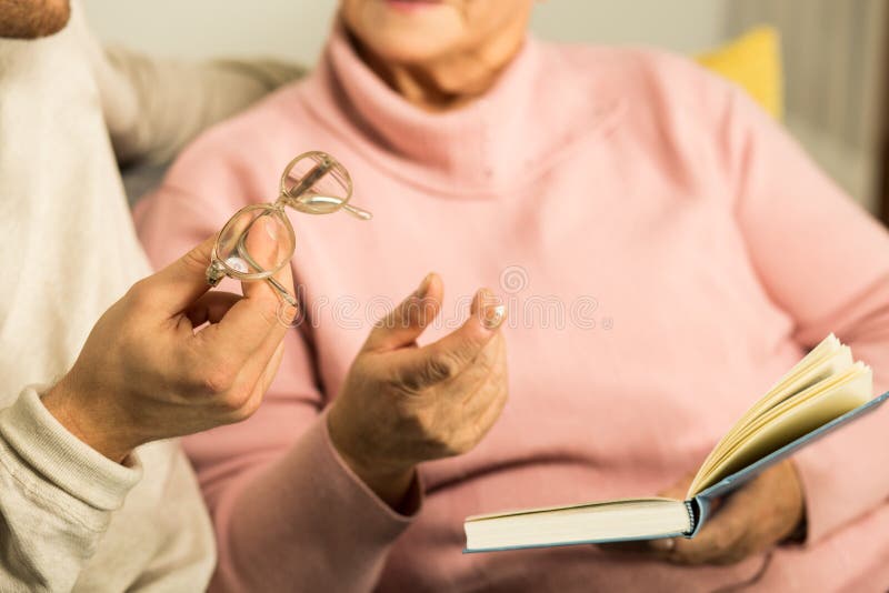 Giving senior woman reading glasses stock image Giving senior woman reading glasses stock image