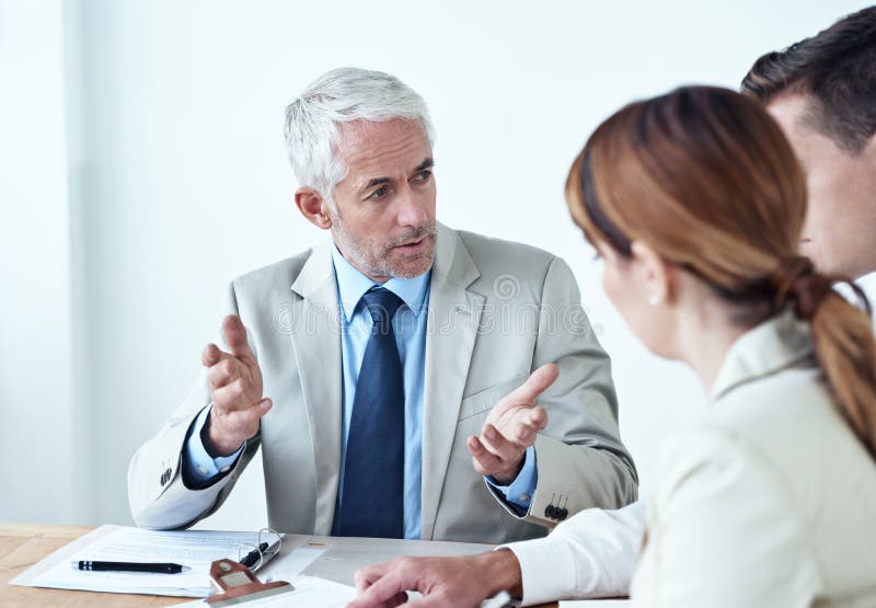 Giving Them His Expert Opinion. Shot of a Group of Colleagues Having a ...