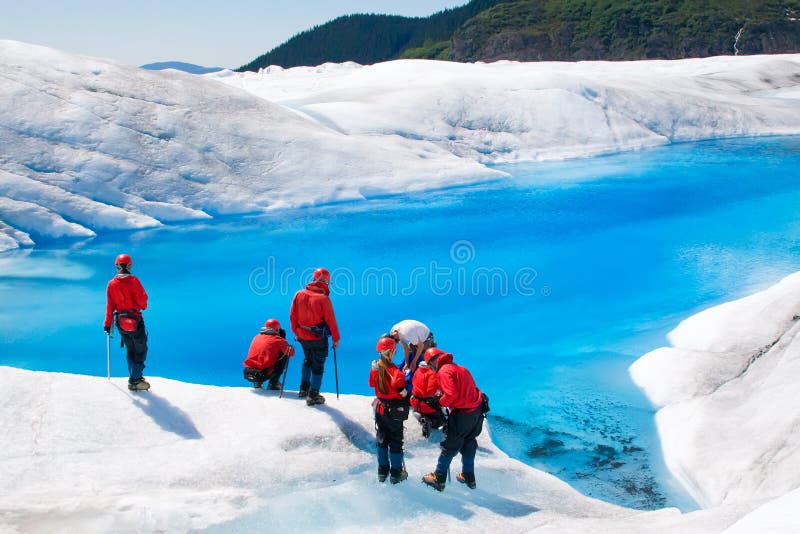 JUNEAU, ALASKA - JUNE 3: Unidentified hikers take a rest at one of the many pools of blue water on top of Mendenhall Glacier on June 3, 2009 in Juneau, Alaska. JUNEAU, ALASKA - JUNE 3: Unidentified hikers take a rest at one of the many pools of blue water on top of Mendenhall Glacier on June 3, 2009 in Juneau, Alaska.