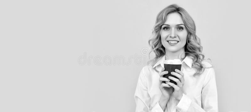 glad blonde woman with morning coffee cup on yellow background. Woman isolated face portrait, banner with mock up copy royalty free stock photos