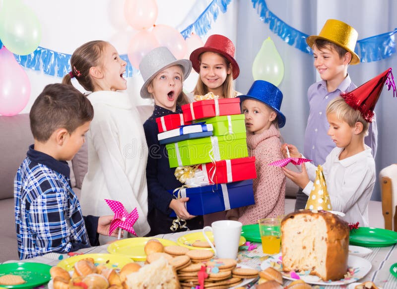 Children Presenting Gifts during Christmas Dinner Stock Photo - Image ...