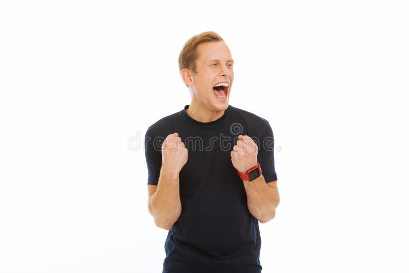 Glad förtjust man som uttrycker hans positiva sinnesrörelser royaltyfria bilder Glad förtjust man som uttrycker hans positiva sinnesrörelser royaltyfria bilder